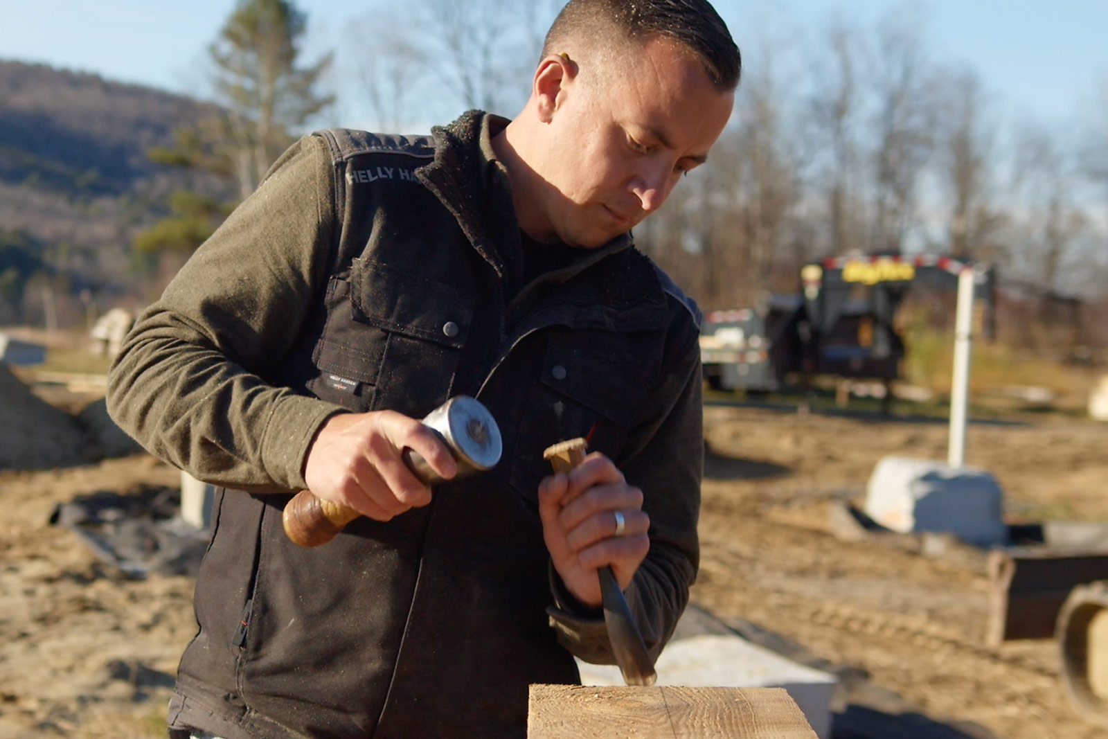 Tim Rau, owner of Legacy Barns, chiseling a beam